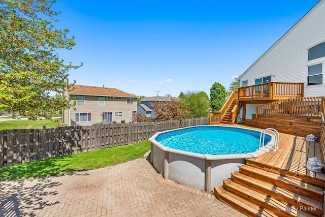 view of swimming pool featuring stairway, a wooden deck, a fenced backyard, and a patio