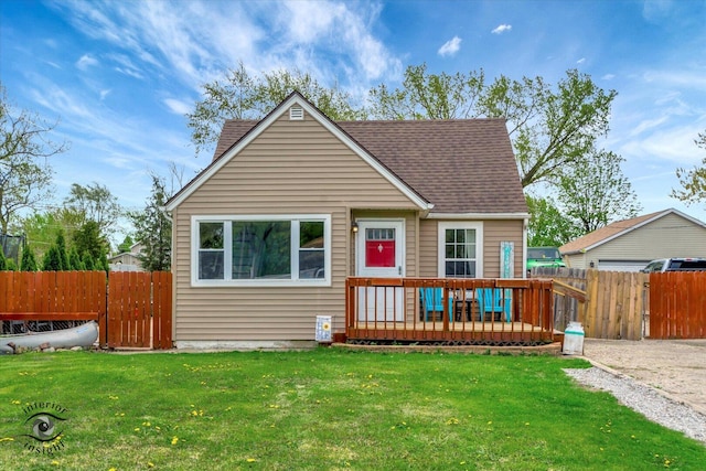bungalow-style house featuring fence, a wooden deck, roof with shingles, and a front lawn