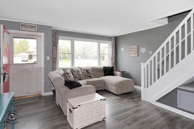 living area with dark wood-type flooring, ornamental molding, baseboards, and stairway