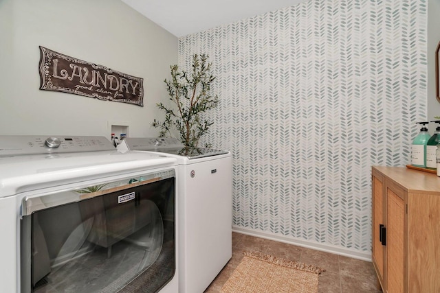 laundry area with separate washer and dryer, baseboards, laundry area, and wallpapered walls