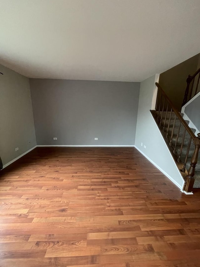 2008 Jamestown Dr Unit 0, Palatine, IL 60074 - unfurnished living room with wood finished floors, stairway, and baseboards