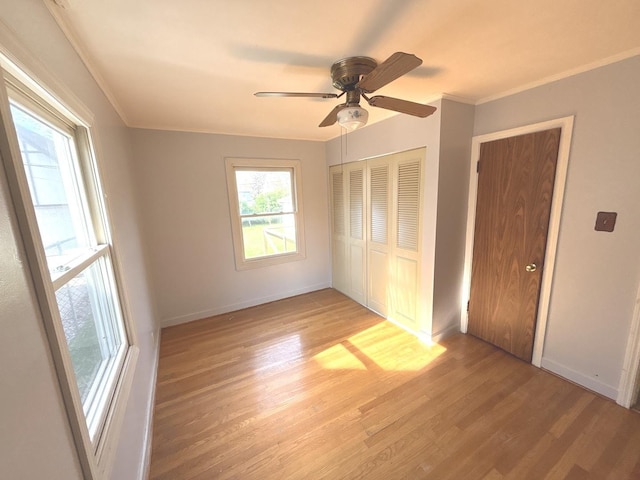 5404 Kimball Pl, Oak Lawn, IL 60453 - unfurnished bedroom featuring light wood finished floors, a closet, baseboards, ornamental molding, and a ceiling fan