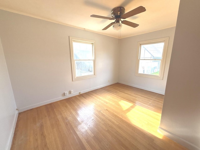 5404 Kimball Pl, Oak Lawn, IL 60453 - empty room with healthy amount of natural light, light wood finished floors, baseboards, ornamental molding, and a ceiling fan