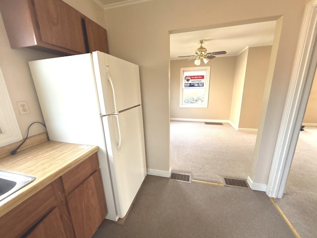 5404 Kimball Pl, Oak Lawn, IL 60453 - kitchen with dark carpet, brown cabinetry, freestanding refrigerator, crown molding, and a ceiling fan