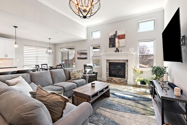 1340 Lacoma Ct, Lockport, IL 60441 - living area with a notable chandelier, plenty of natural light, ornamental molding, and a fireplace