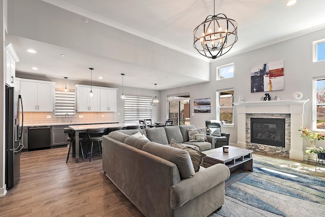 1340 Lacoma Ct, Lockport, IL 60441 - living area with recessed lighting, a chandelier, a stone fireplace, and wood finished floors