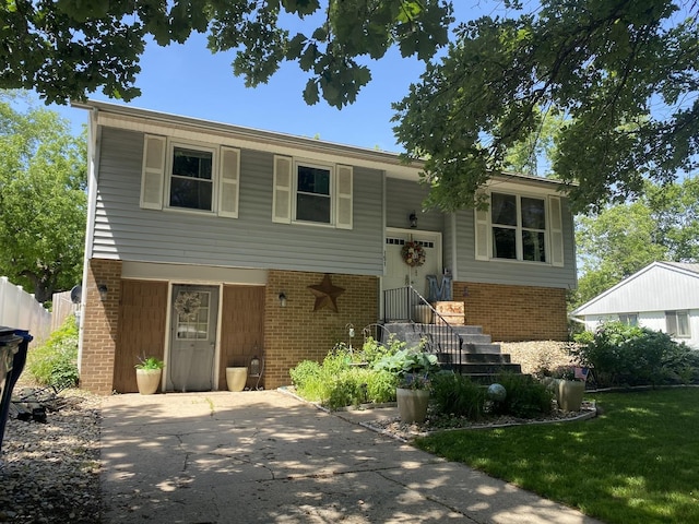 raised ranch with brick siding and fence