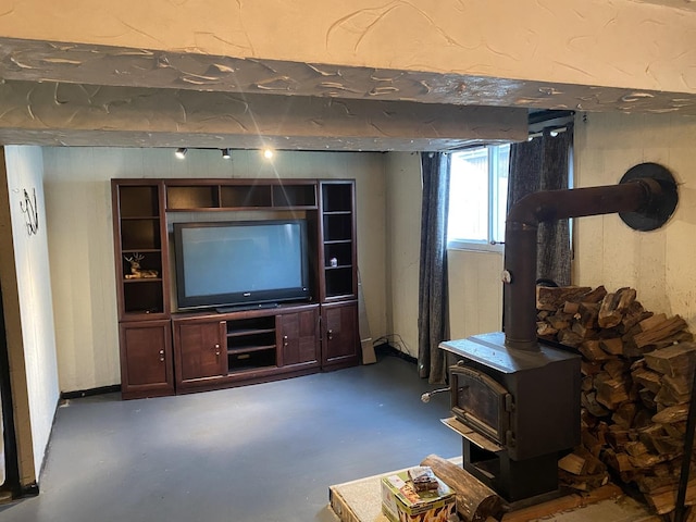 living room with concrete flooring and a wood stove