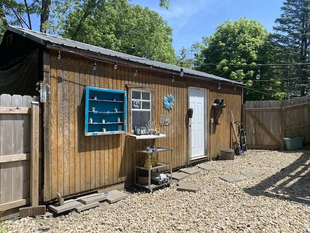 view of outbuilding featuring an outbuilding and fence