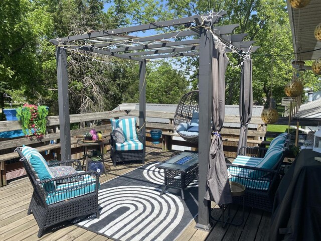 wooden deck with a pergola and an outdoor living space