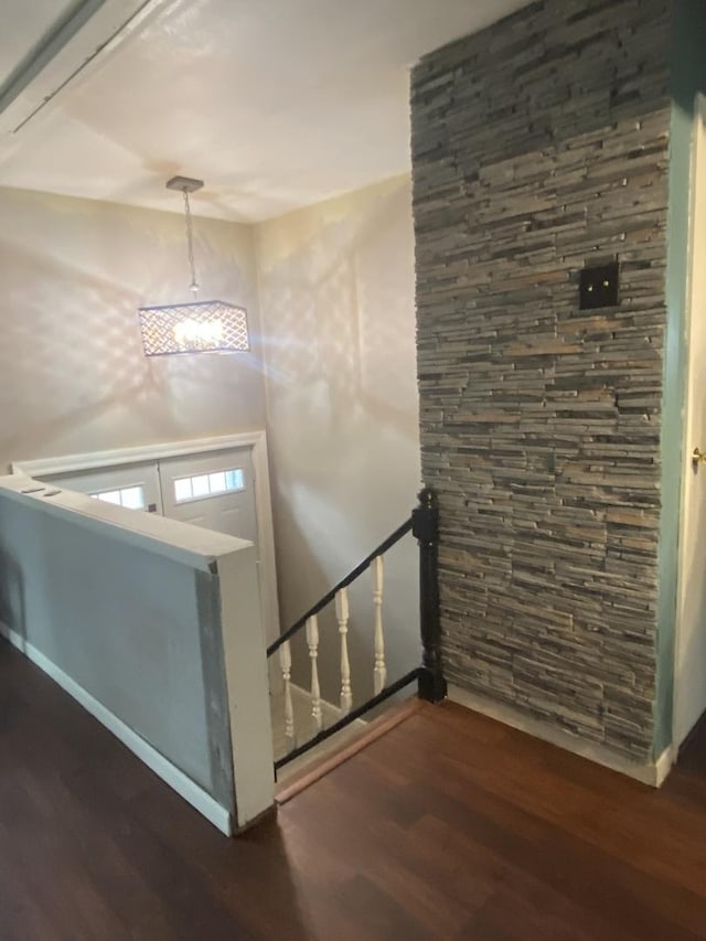 foyer featuring baseboards and wood finished floors