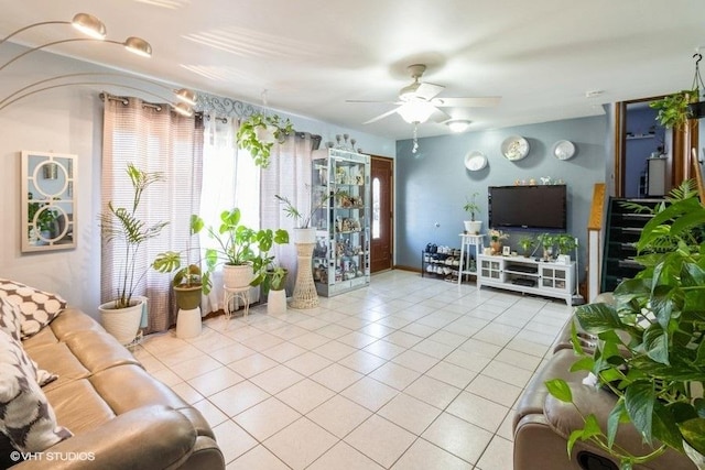 living room featuring tile patterned floors and a ceiling fan