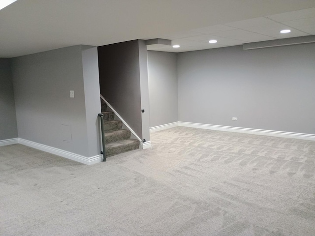 finished basement featuring baseboards, recessed lighting, stairway, and carpet flooring