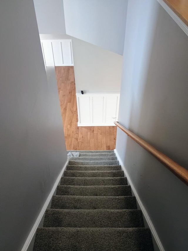 stairs featuring wood finished floors