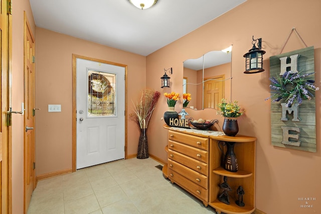 entrance foyer featuring light tile patterned floors and baseboards
