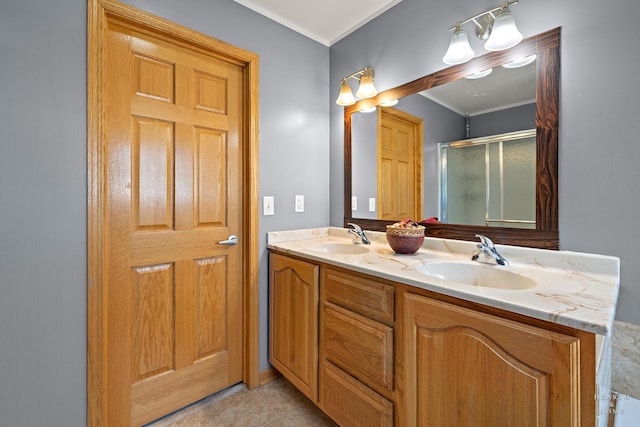 bathroom featuring crown molding, double vanity, a sink, and a stall shower