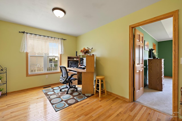 home office featuring baseboards, visible vents, and wood finished floors