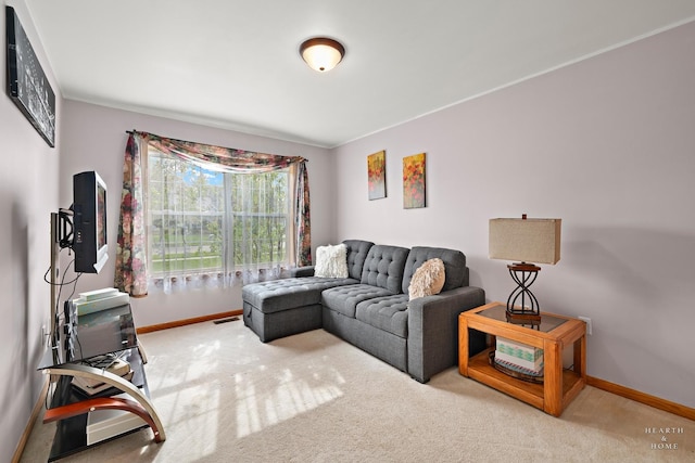 carpeted living area with baseboards, ornamental molding, and visible vents