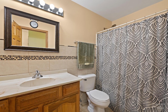 full bathroom featuring toilet, tile walls, curtained shower, and vanity