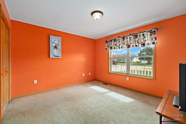 interior space featuring baseboards, carpet, and visible vents