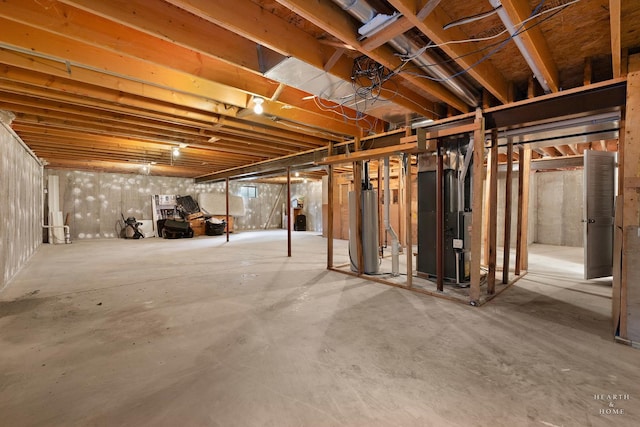 unfinished basement with heating unit and gas water heater
