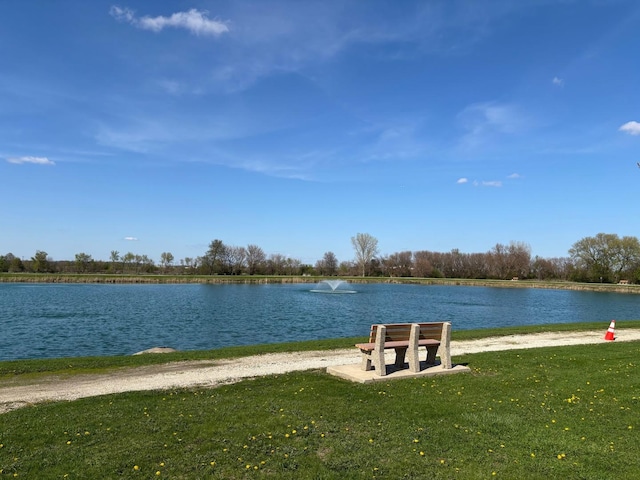 exterior space featuring a lawn and a water view
