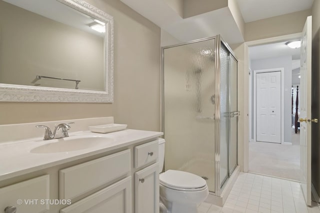 bathroom with vanity, tile patterned flooring, a stall shower, and toilet