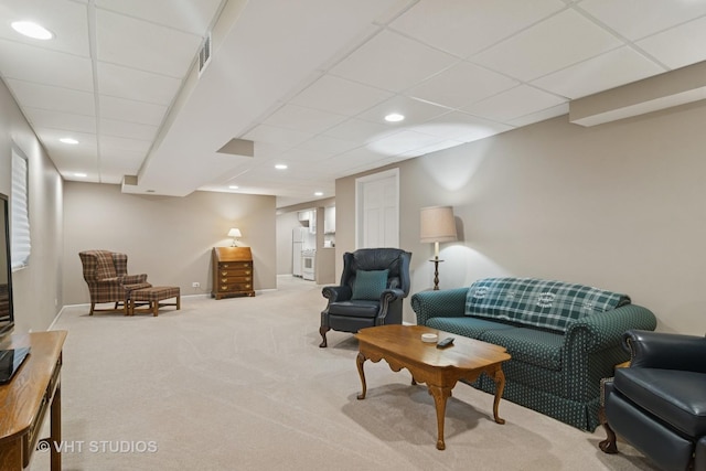 living room with recessed lighting, carpet, baseboards, and a paneled ceiling