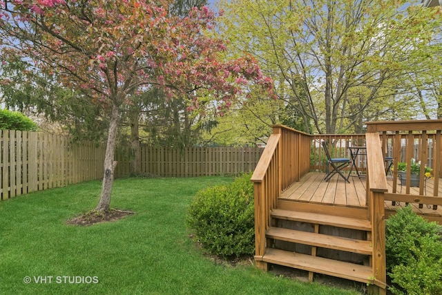 view of yard with a deck and a fenced backyard