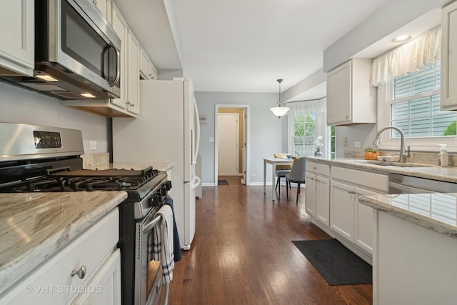 kitchen featuring white cabinets, stainless steel appliances, a sink, and dark wood-type flooring