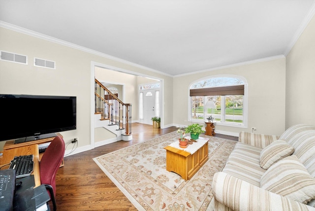 living room featuring stairway, visible vents, and ornamental molding