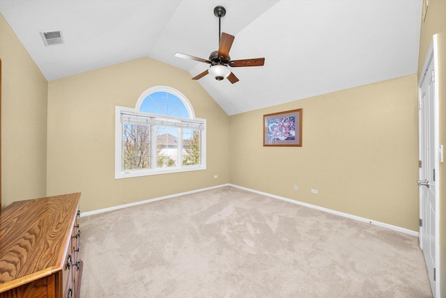 interior space featuring baseboards, visible vents, ceiling fan, and vaulted ceiling