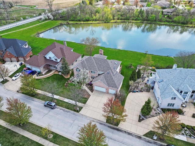 drone / aerial view with a residential view and a water view
