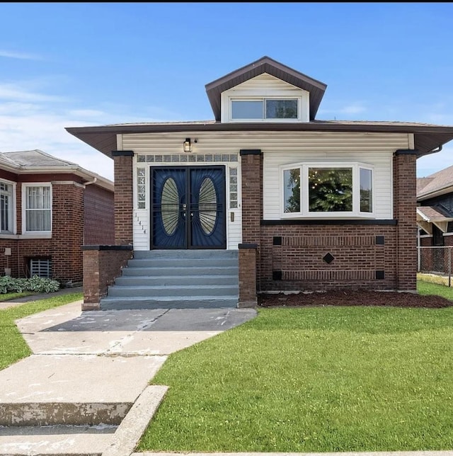 11414 S Wallace St, Chicago, IL 60628 - view of front of house with a front yard and brick siding
