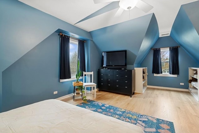 bedroom with baseboards, wood finished floors, and lofted ceiling