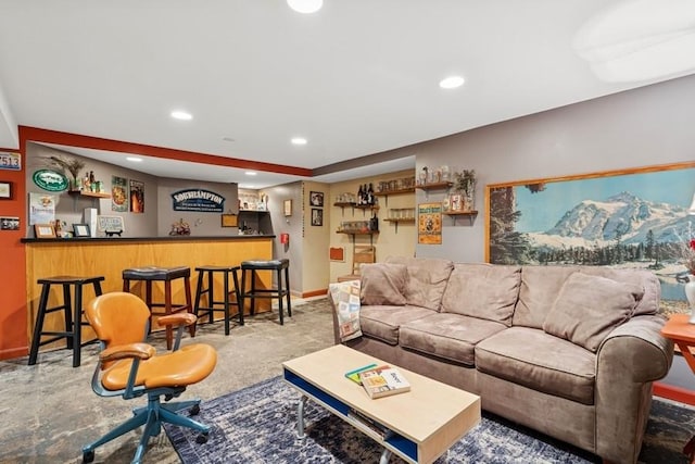living area with recessed lighting, baseboards, and a bar