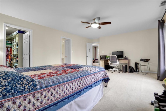 carpeted bedroom featuring visible vents, a ceiling fan, and a spacious closet