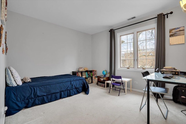 carpeted bedroom with visible vents and baseboards