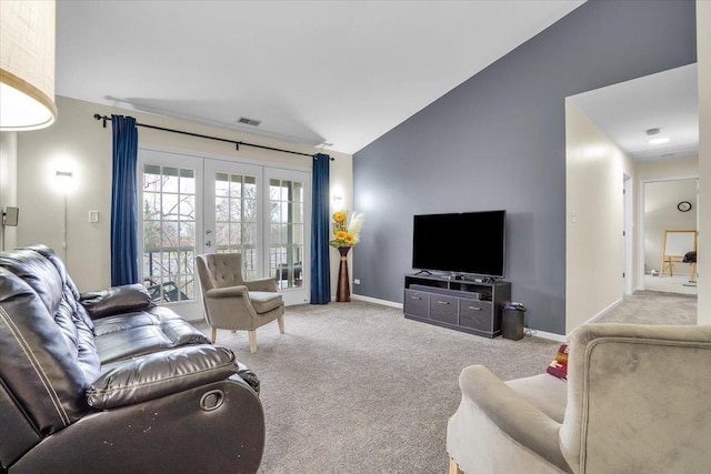 living area with baseboards, visible vents, lofted ceiling, and carpet