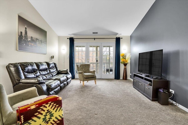 carpeted living room with baseboards, visible vents, and vaulted ceiling