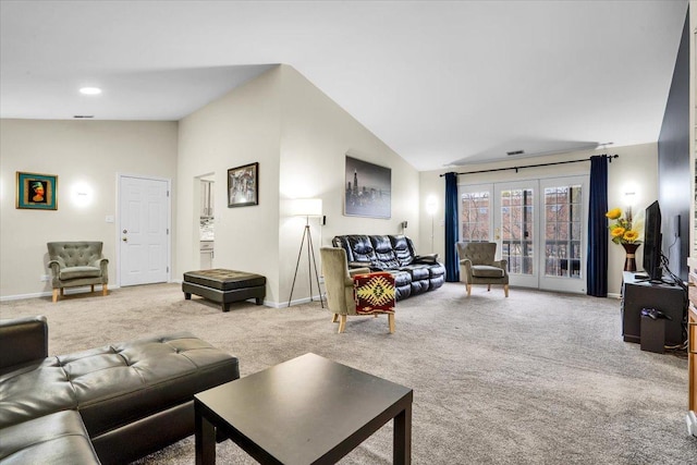 carpeted living room with baseboards and vaulted ceiling