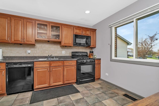 1 Red Wing Ct, Woodridge, IL 60517 - kitchen featuring a sink, brown cabinets, tasteful backsplash, black appliances, and visible vents