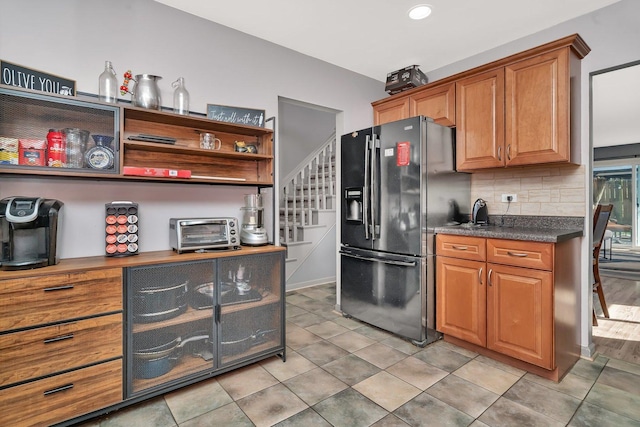 1 Red Wing Ct, Woodridge, IL 60517 - kitchen featuring dark countertops, brown cabinets, backsplash, and black fridge