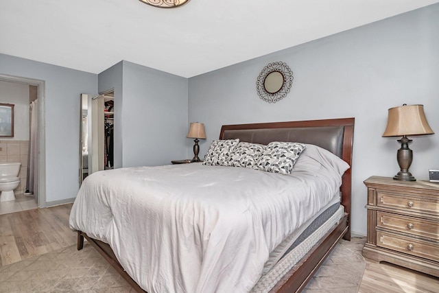 1 Red Wing Ct, Woodridge, IL 60517 - bedroom with a spacious closet, wood finished floors, ensuite bathroom, and a closet