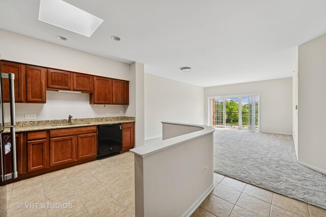 3501 Wellington Ct Unit 410, Rolling Meadows, IL 60008 - kitchen with dishwasher, light colored carpet, a skylight, light tile patterned floors, and open floor plan