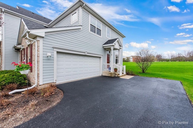 view of property exterior featuring a lawn, driveway, a shingled roof, and a garage