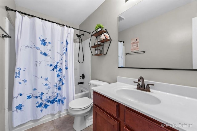 bathroom featuring vanity, tile patterned flooring, shower / bath combo with shower curtain, and toilet