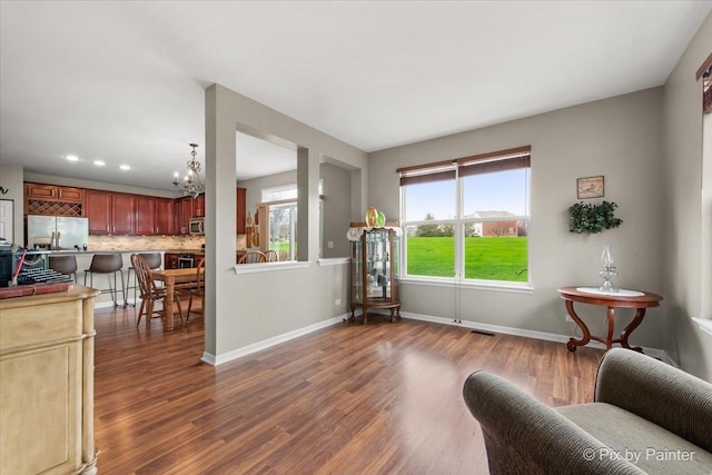 interior space with visible vents, baseboards, dark wood-style floors, recessed lighting, and a notable chandelier