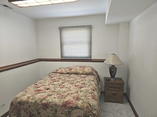 bedroom with baseboards, visible vents, and marble finish floor