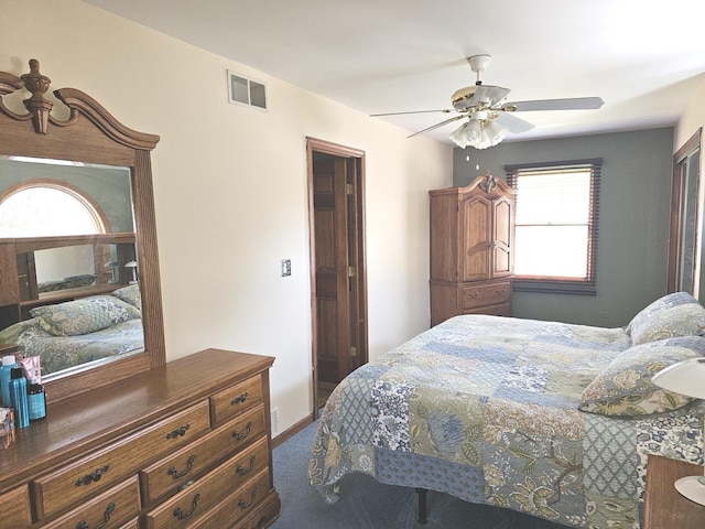 carpeted bedroom featuring visible vents and ceiling fan